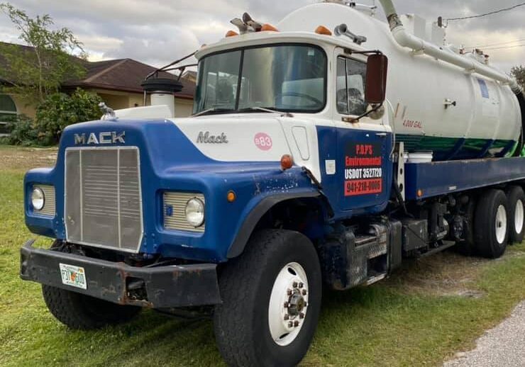 P.O.P'S Environmental Septic Truck in residential front yard while performing septic pump out in North Port Florida