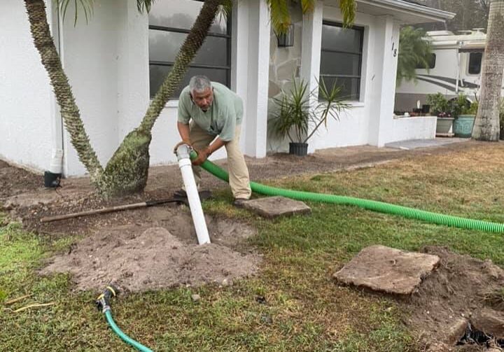 P.O.P'S Environmental owner Alex Dominguez inspects septic tank as he performs a septic pump out in Port Charlotte Florida