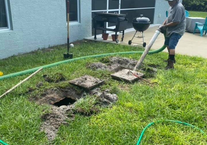 P.O.P'S Environmental owner Alex Dominguez pumps out backed up septic tank in residential back yard in Desoto County Florida